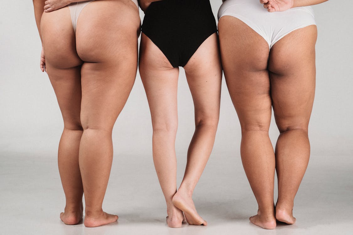 Crop unrecognizable women in underwear standing against white background ·  Free Stock Photo