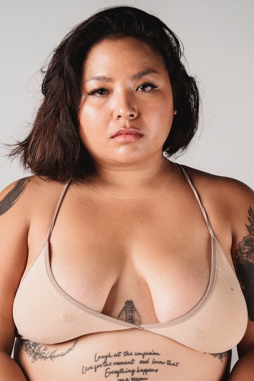 Serious Asian plump woman in bra