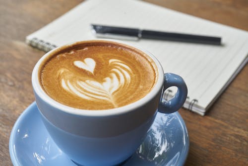 Free Coffee Latte Beside Spring Notebook Stock Photo