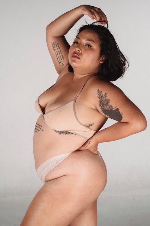 Overweight Asian woman with hand on waist