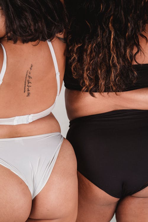 Free Overweight women in underwear leaning on each other Stock Photo
