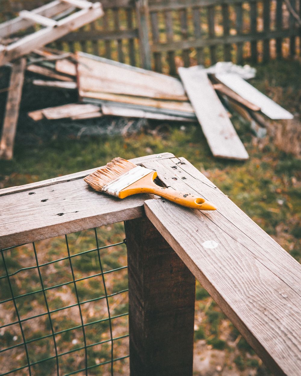 Paint brush on outdoor wood for deck staining