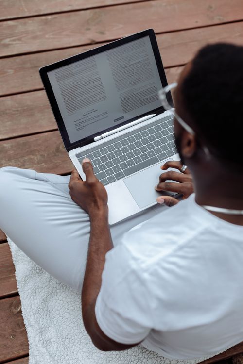 Guy Reading Computer A Man Reading Documents on His Laptop · Free Stock Photo