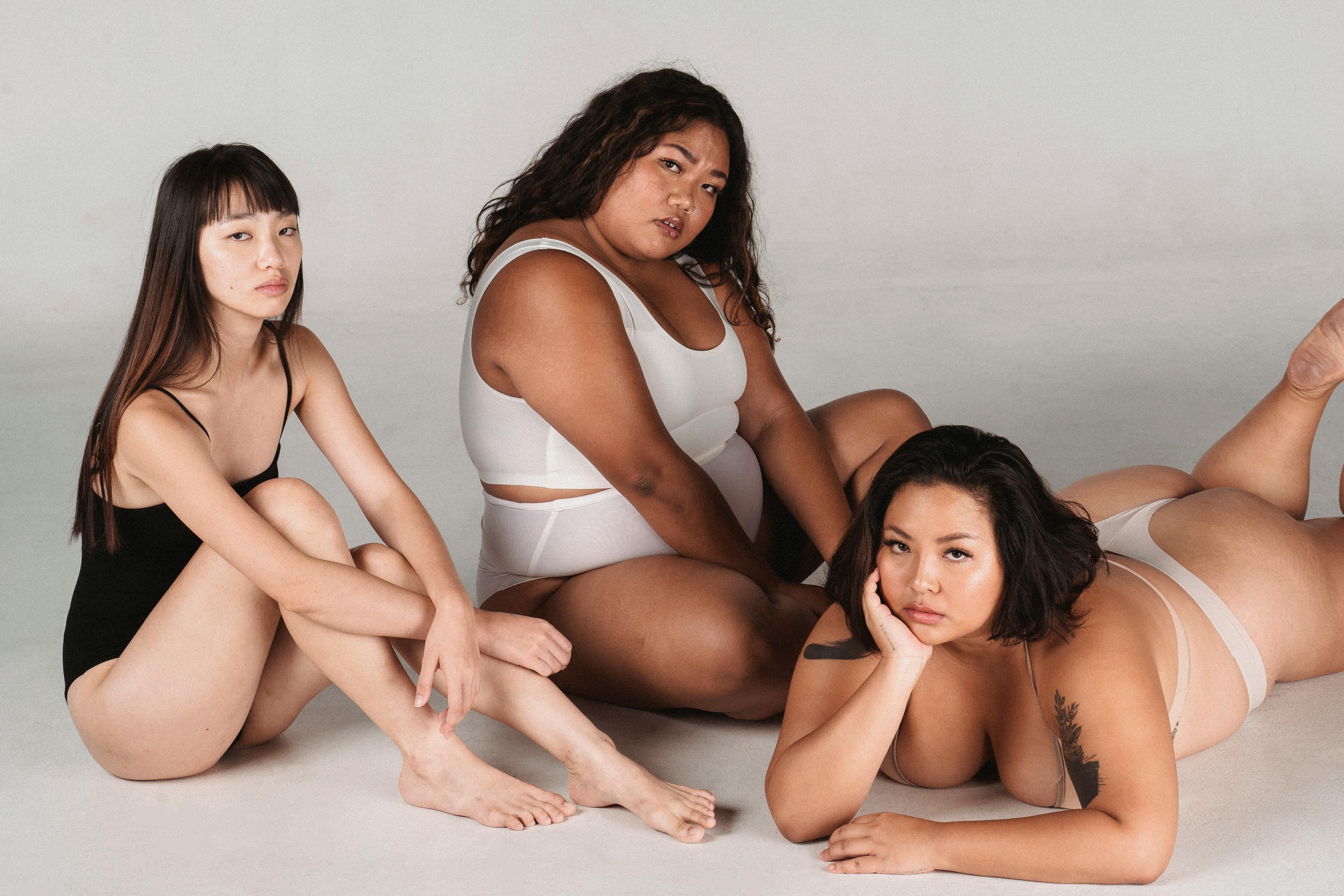 Relaxed Asian women in lingerie on floor · Free Stock Photo