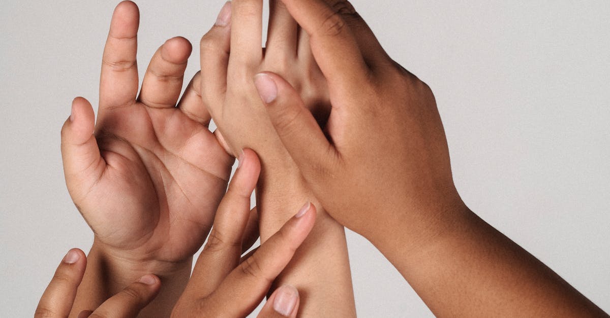 Crop multiracial unrecognizable female joining hands together supporting each other and accepting individuality of each other