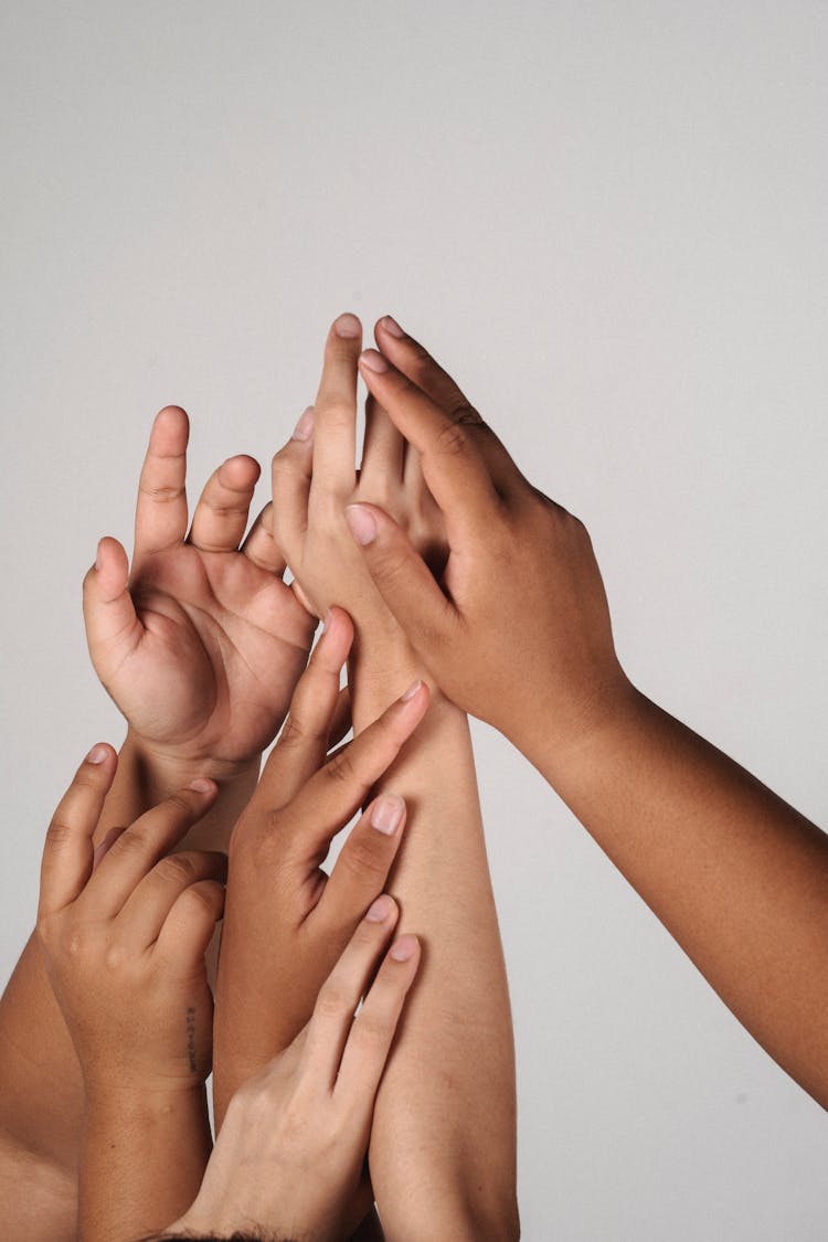 Diverse Women Put Hands Together In Studio