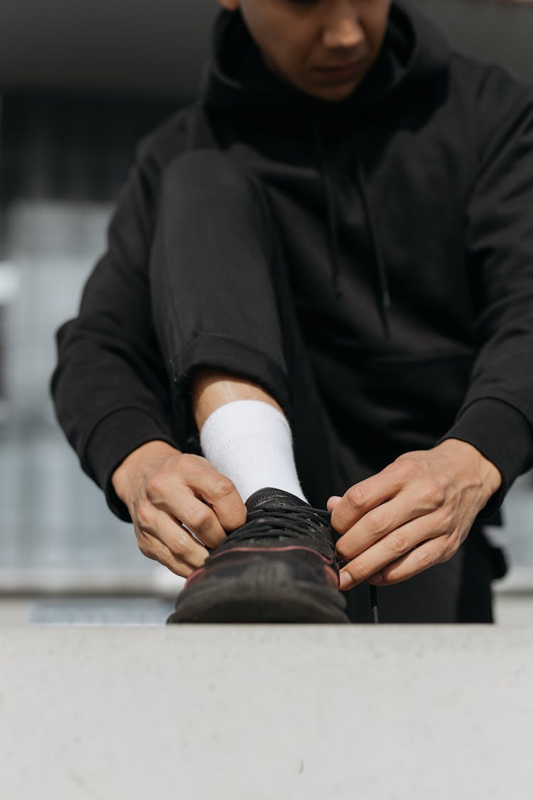 A Person Tying His Shoes