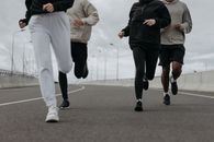 四个人在城市道路上慢跑，展现了健身与团队合作