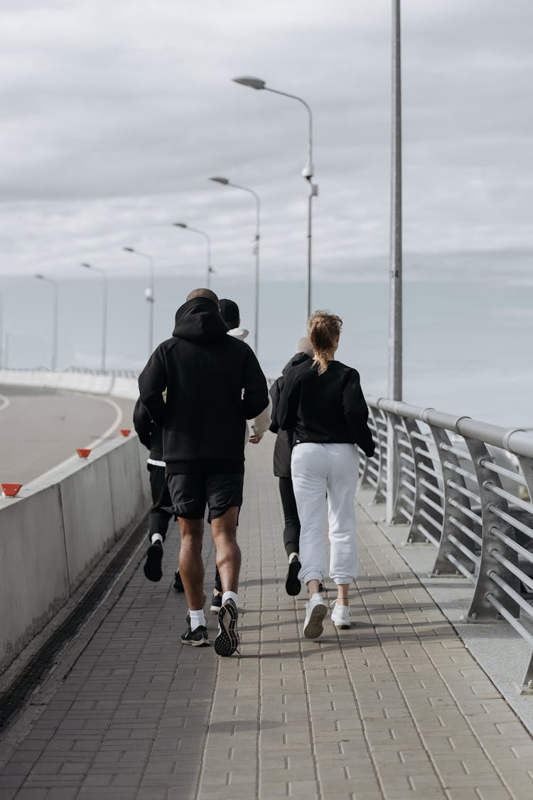 A People Doing Jogging On The Sidewalk