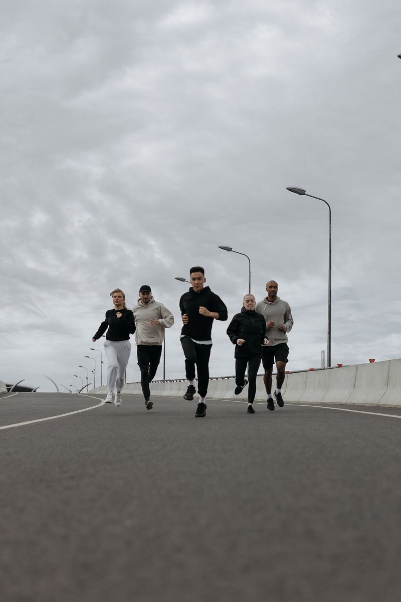 Group of runners on a city bridge, photo by cottonbro studio on Pexels