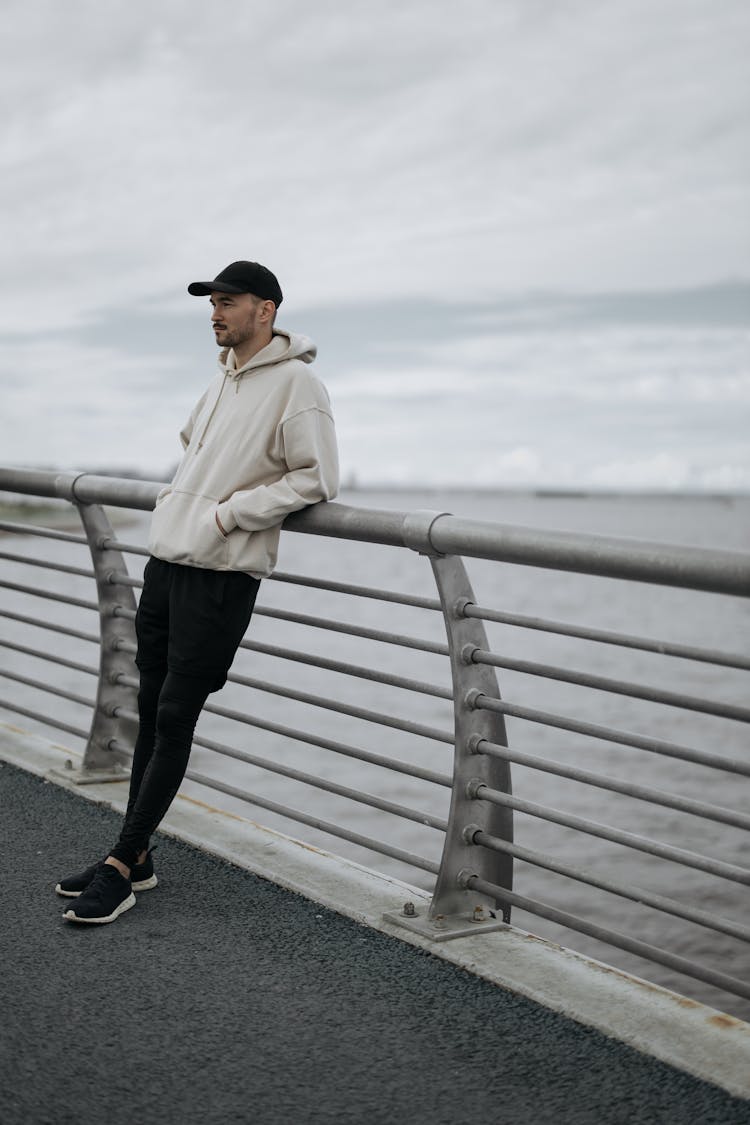 A Man Leaning On The Fence