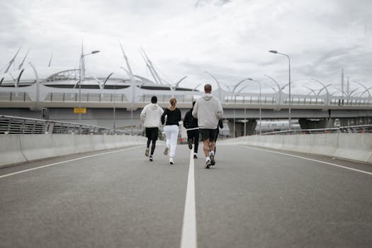 Diverse group jogging on a modern bridge in sportswear, promoting health.