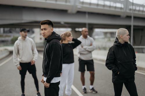 Free A diverse group of friends wearing activewear in an urban setting. Ideal for lifestyle and sports themes. Stock Photo