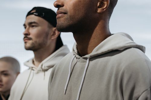 Free A diverse group of adults in hoodies stand outdoors exhibiting solidarity. Stock Photo