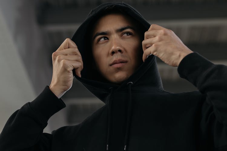 A Man Wearing A Black Hoodie Jacket