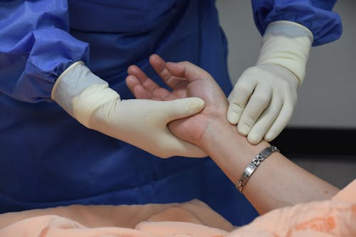 A Medical Professional Checking a Patients Pulse