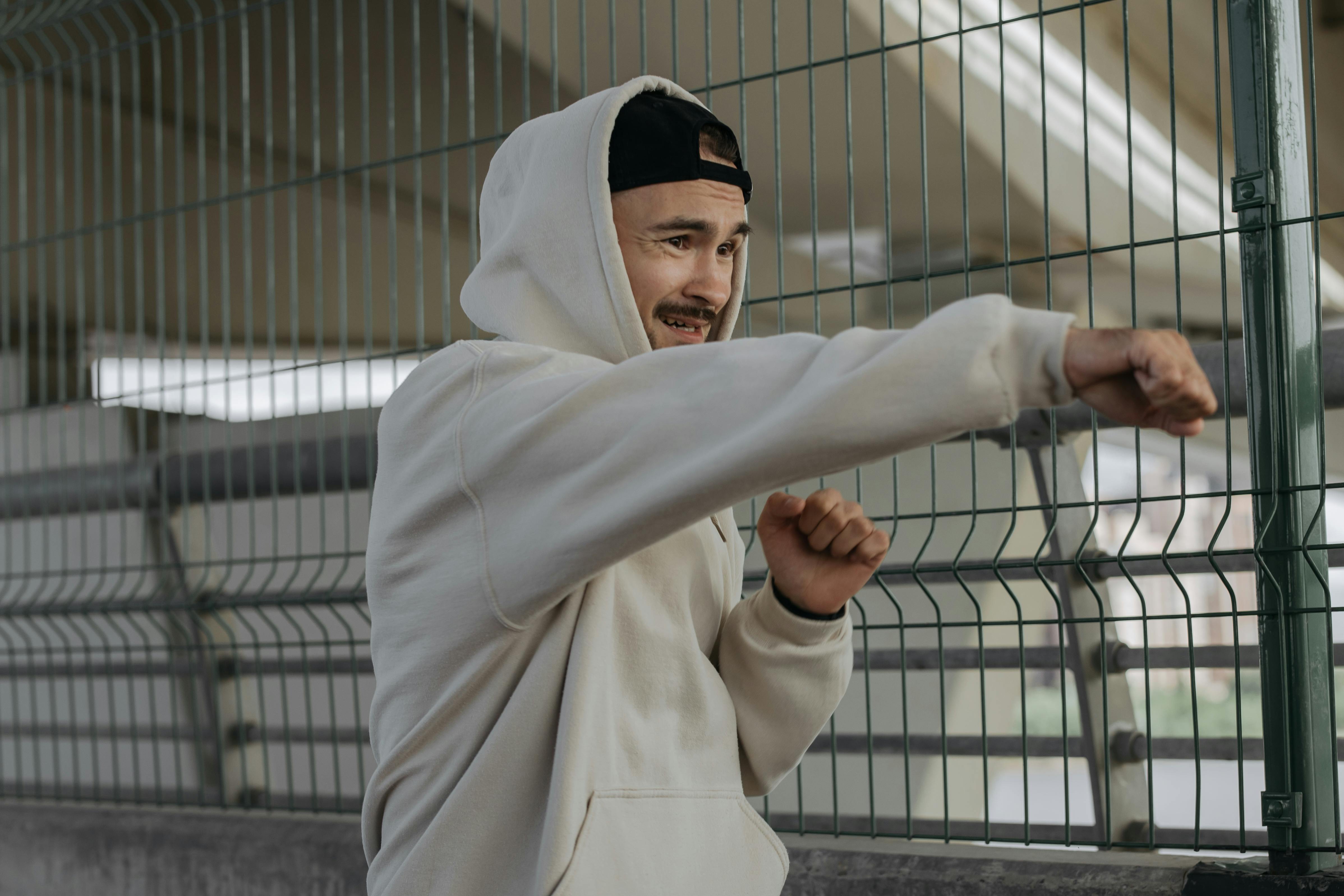 a man in a hoodie jacket throwing a punch