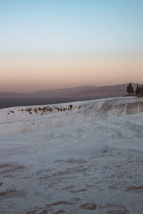 Free Beautiful sunset view of Pamukkale's white travertine terraces in Turkey, offering a serene natural landscape. Stock Photo
