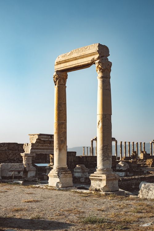 Free Explore the majestic ruins of Laodicea with its towering columns and clear blue sky. Stock Photo