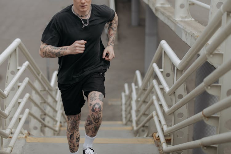 A Man Running On Concrete Stairs