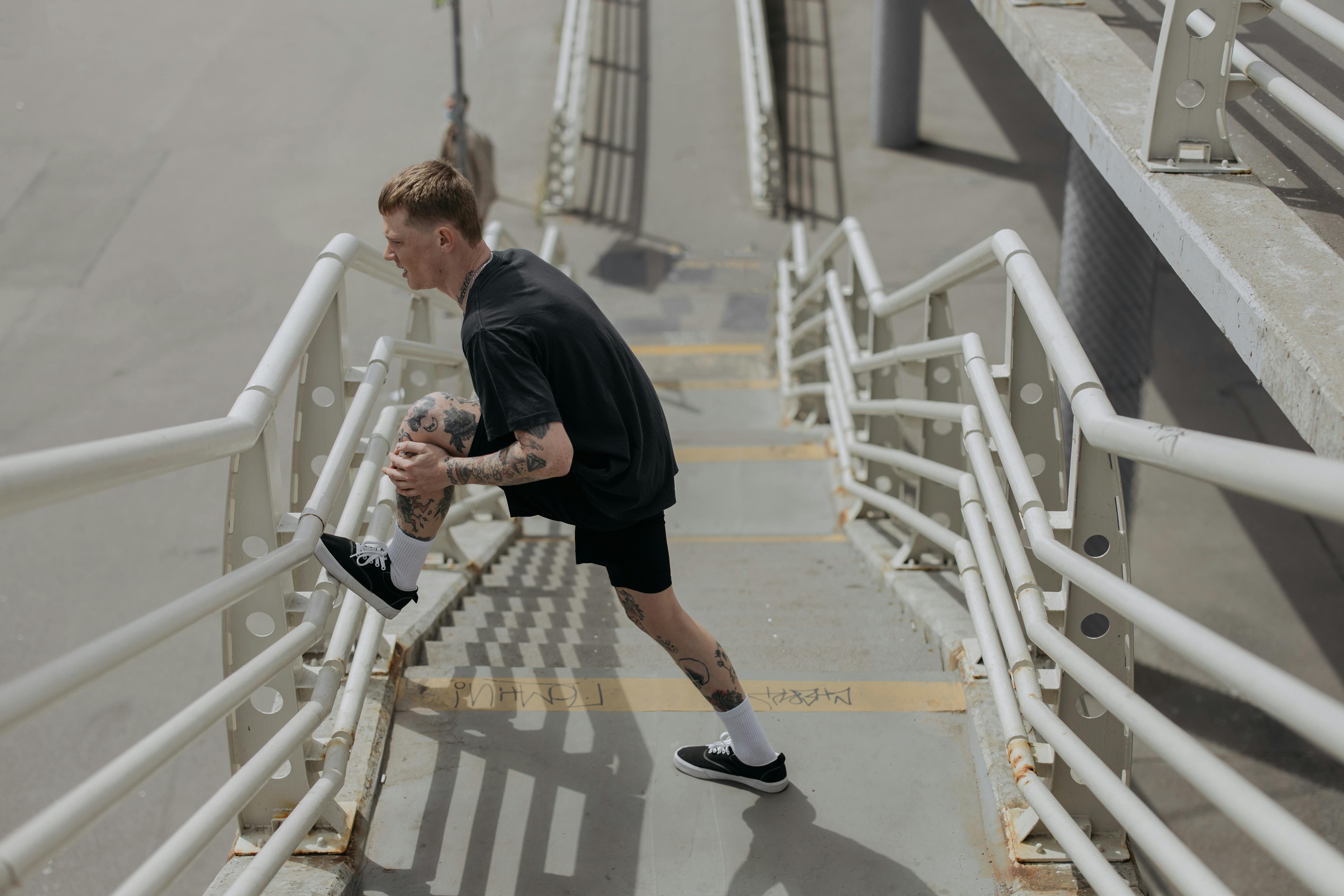 person warming up with dynamic stretches - after workout sore