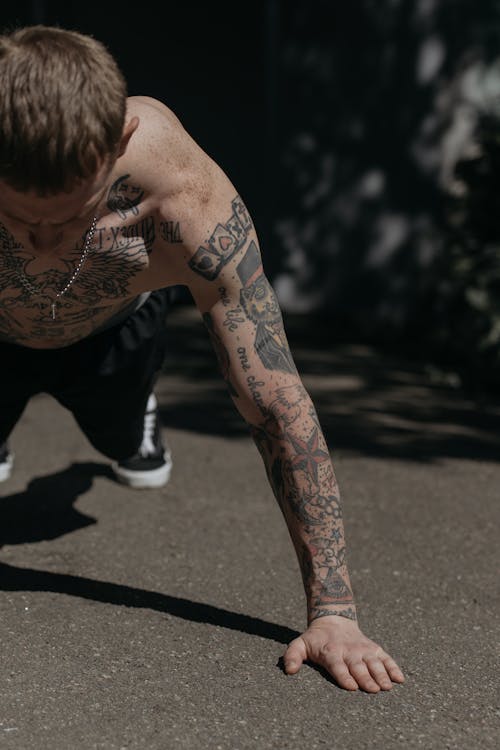 Free Man in Black Shorts With Tattoo on His Body Doing Push Ups Stock Photo