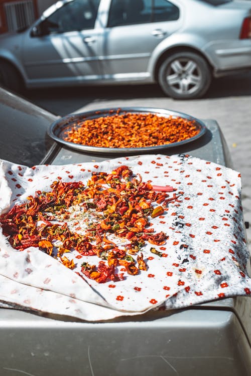 Free Drying Chili Peppers on Textile on Top of the Parked Car Stock Photo