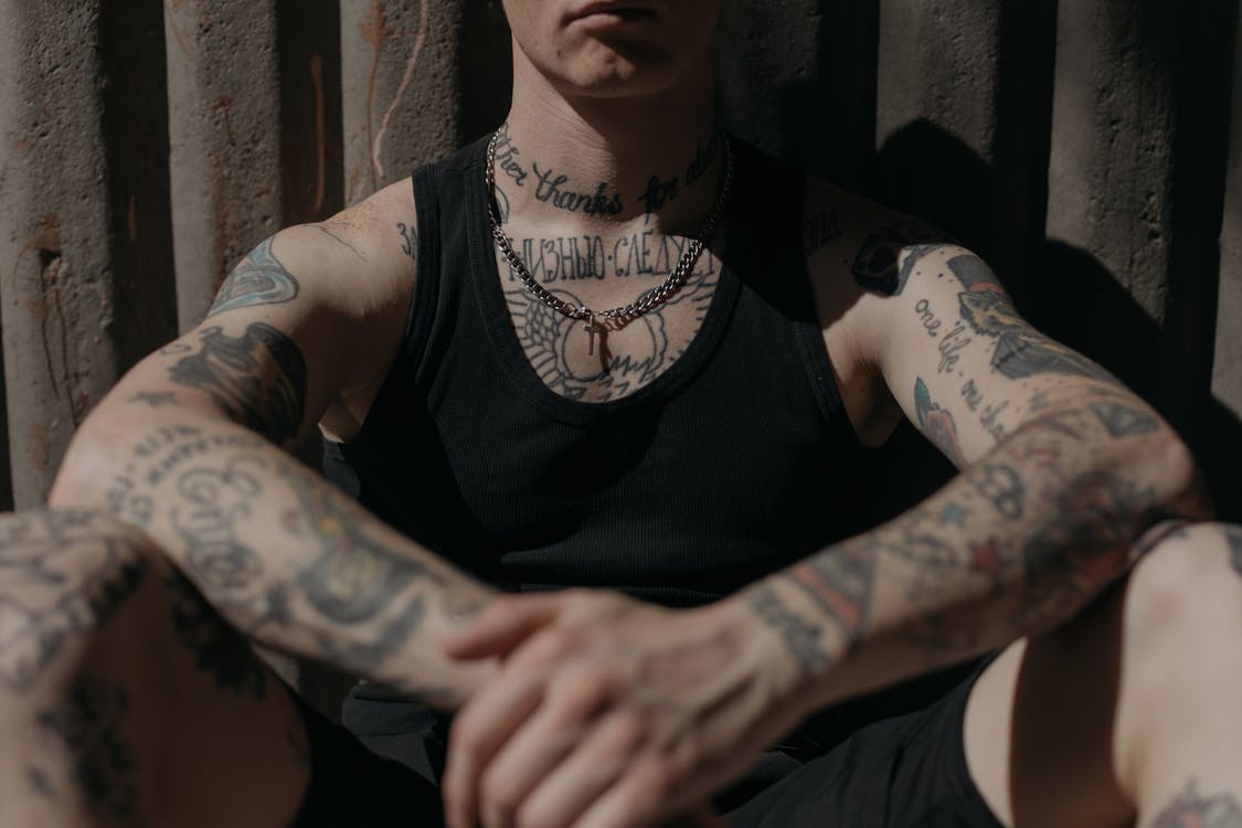 Free A Tattooed Man Wearing Black Tank Top Stock Photo