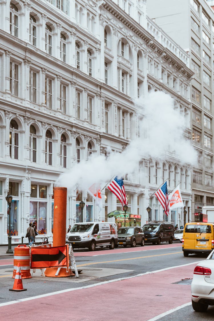 Busy Repairing Street With Cars And Steam From Pipe