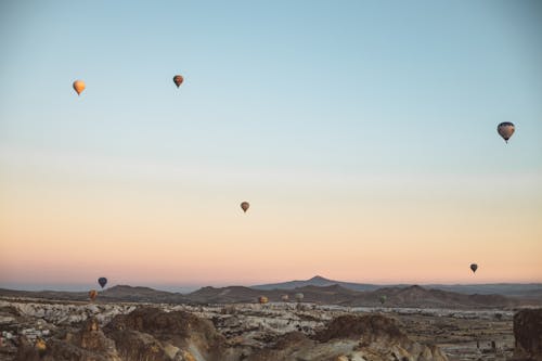 Hot Air Balloons Flying Over the Mountains 