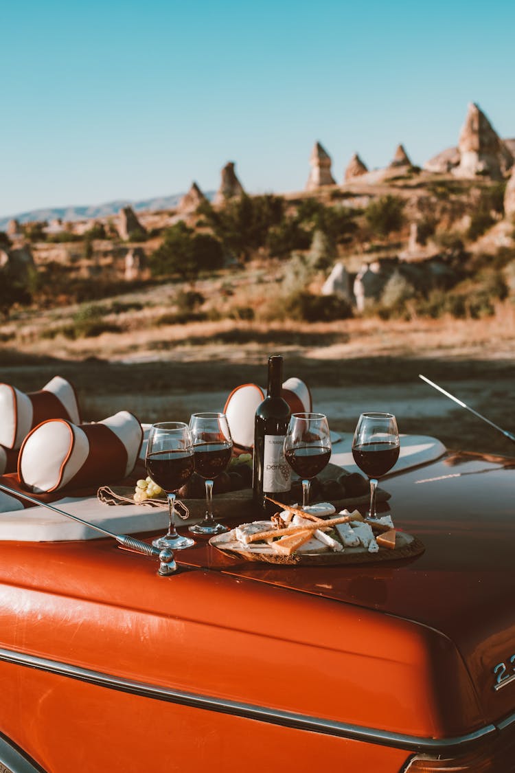 Wine And Food On The Trunk Of A Red Car