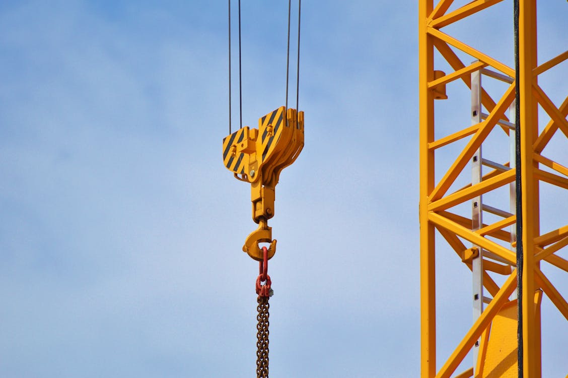 A yellow crane hoist on a construction site