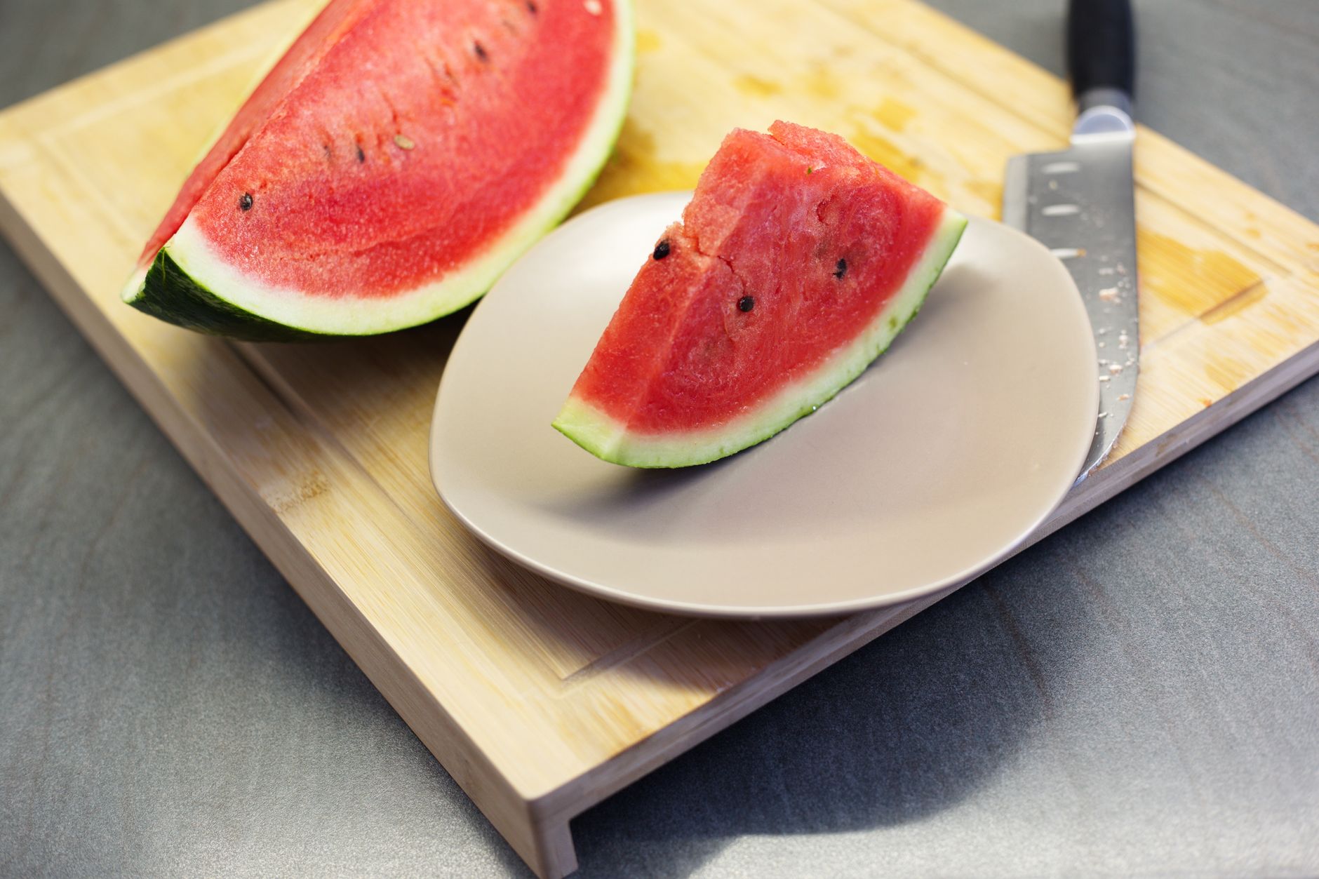 Bright watermelon sticks perfectly cut and arranged on a wooden board