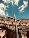 Wooden Cross on Ruins against Blue Sky