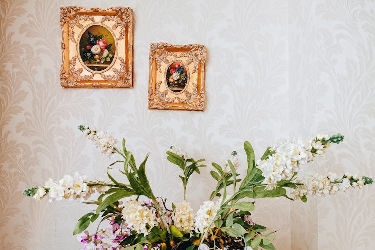 Blooming Flower Bouquet Near Pictures On Wall At Home