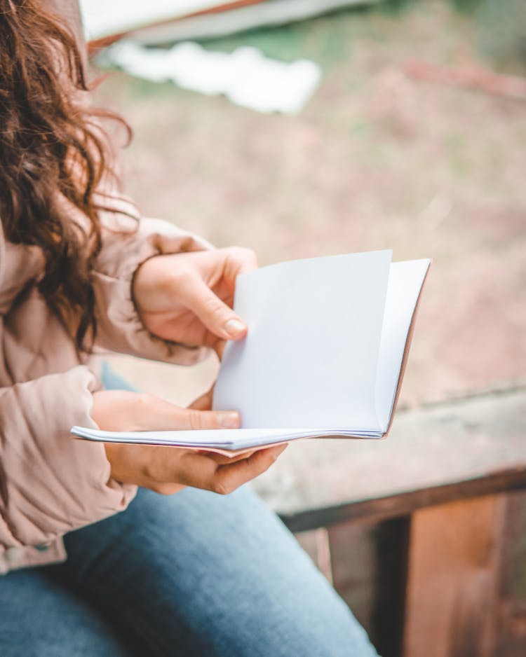 Close Up Photo Of A Person Holding A Sketchbook