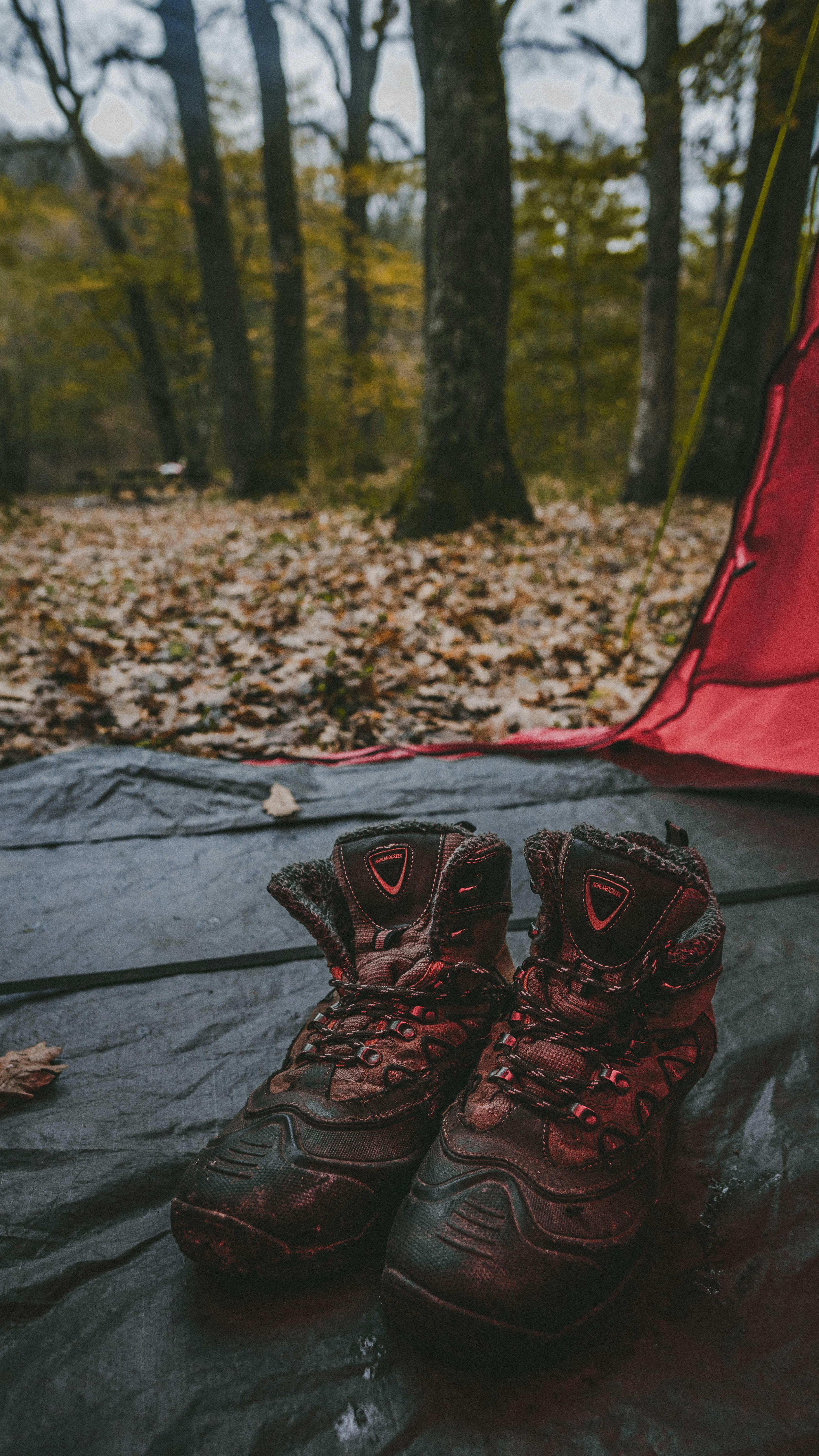 black and red hiking shoes on gray textile