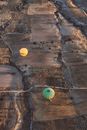 Yellow Balloons on Brown Rock Formation