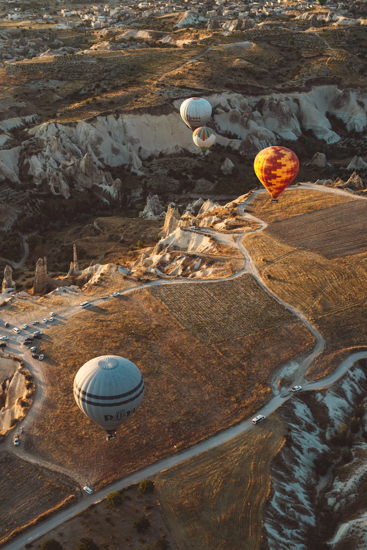 Hot Air Balloons Flying Over A Canyon 