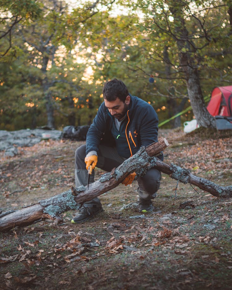 A Man Cutting A Wood