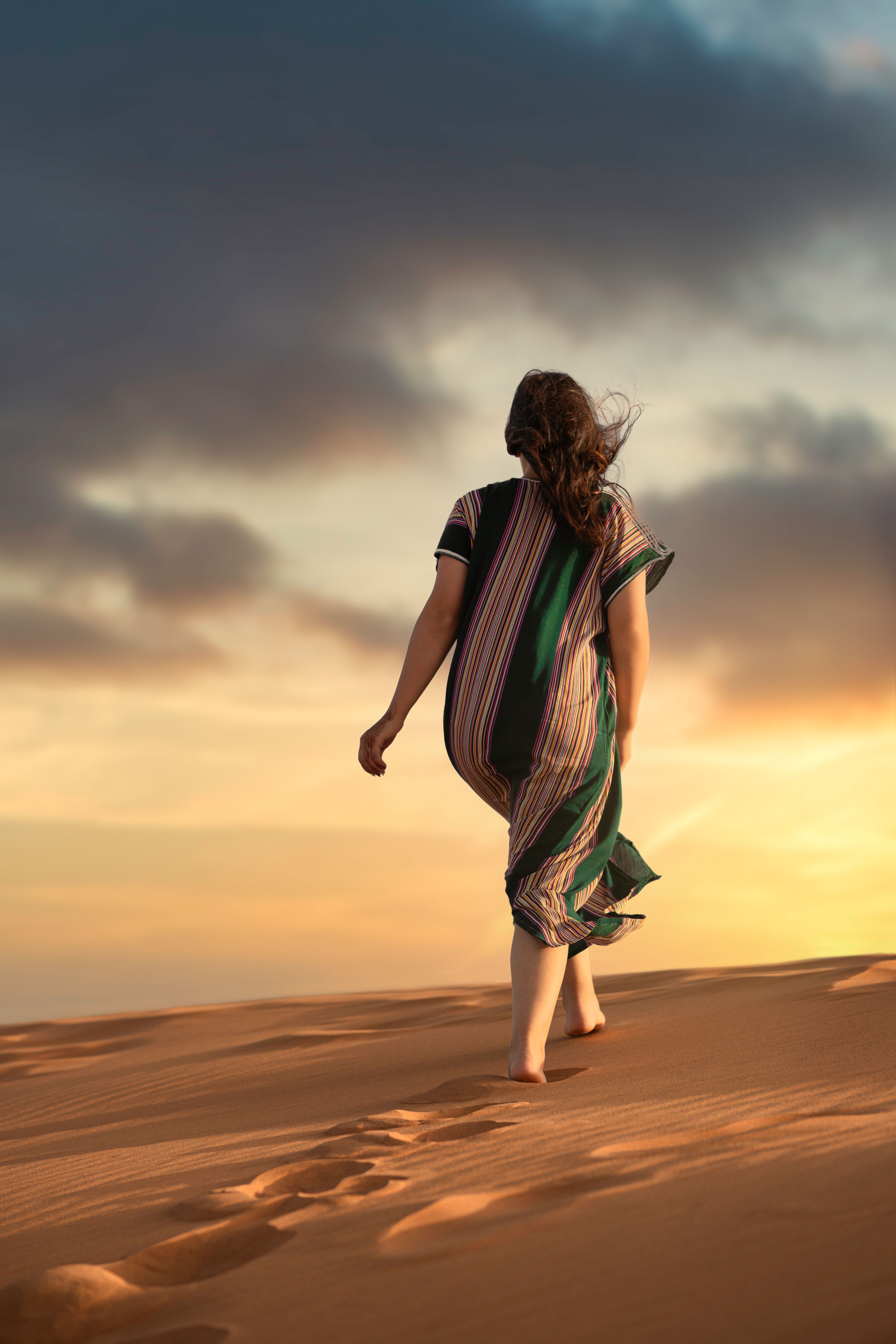 A Woman Walking Alone on a Wooden Pathway on a Desert · Free Stock Photo