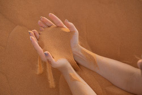 Sand on a Person's Hands