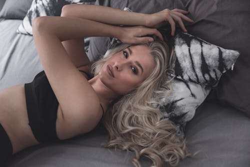 Free Beautiful Woman Lying on Bed Stock Photo