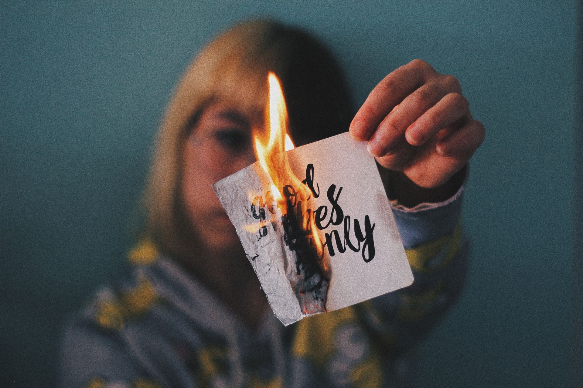 Anonymous woman burning paper with inscription