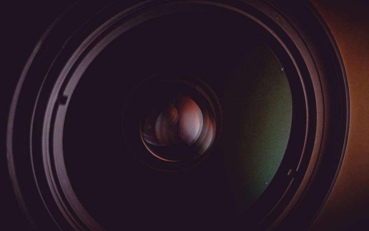 detailed macro shot of a camera lens with visible reflections and vibr