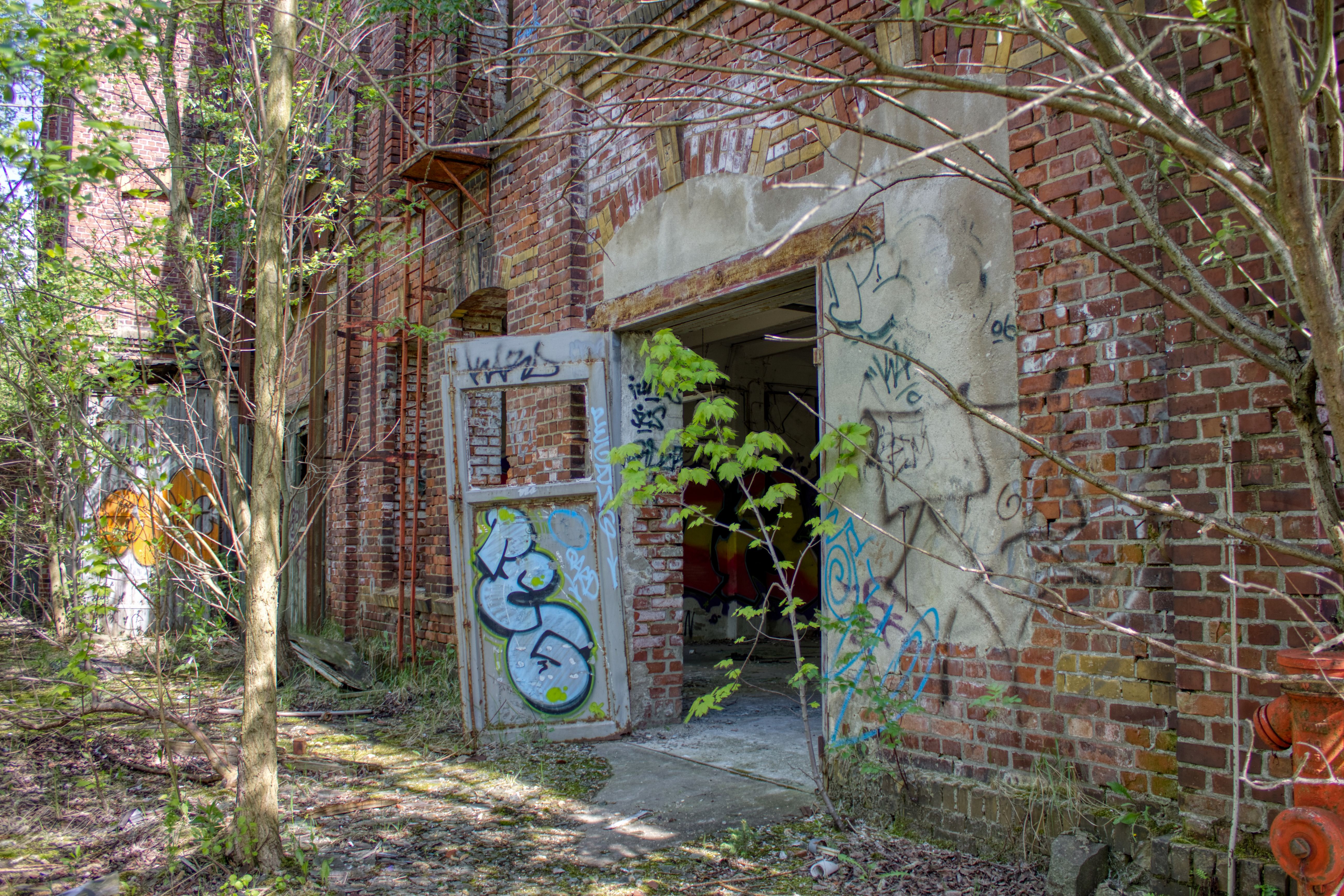 Abandoned Brick Building Near Trees · Free Stock Photo