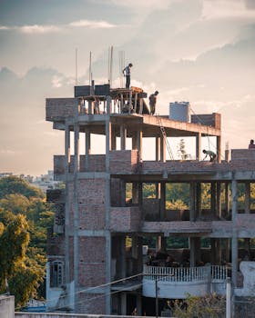 Workers engaged in construction on a brick building in Hyderabad, India.