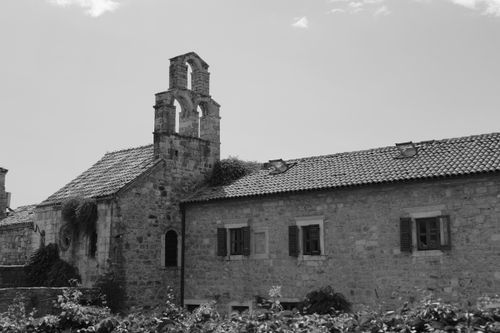 Free A classic stone building with arched windows and a tiled roof in Budva, Montenegro. Stock Photo