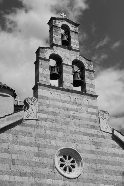Free Black and white photo of a gothic church bell tower in Budva, Montenegro, showcasing architectural details. Stock Photo