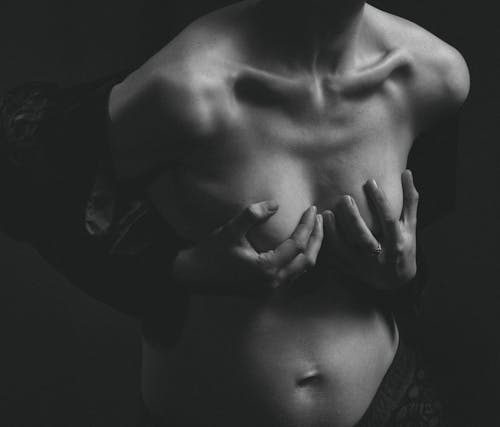 Grayscale Photography of Woman Holding Her Breasts